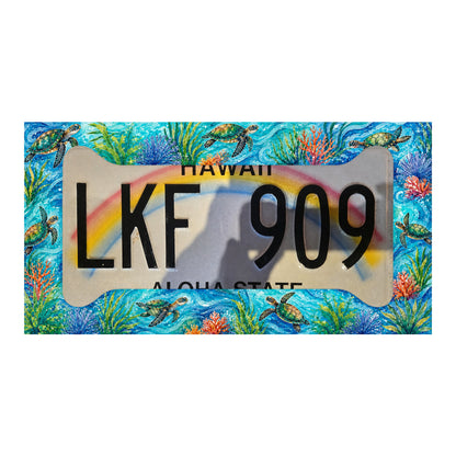 Illustrative mockup of the turquoise sea turtle and coral frame over a Hawaii rainbow license plate; plate not included.