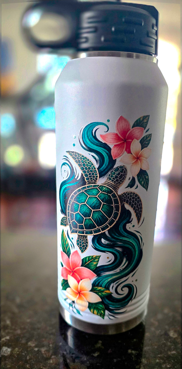 White 32 oz insulated water bottle with green sea turtle, teal ocean waves, and pink and cream plumeria flowers, black flip-top straw lid