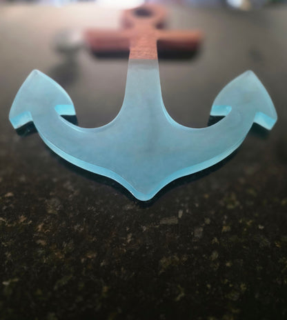 Close-up of translucent blue resin anchor points and the mahogany-to-resin transition