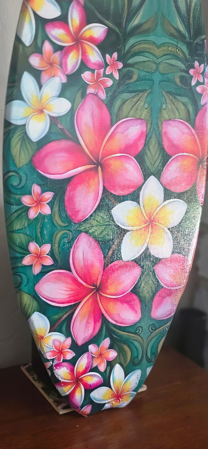 Close-up of the pink and white plumeria flower design on the tropical surfboard wall art