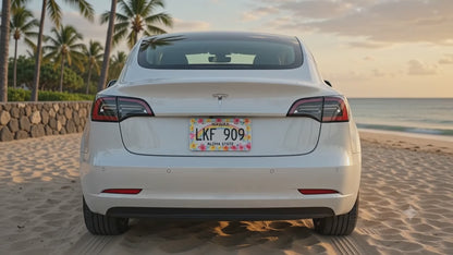 Watercolor plumeria license plate frame shown installed on a white car by a tropical beach