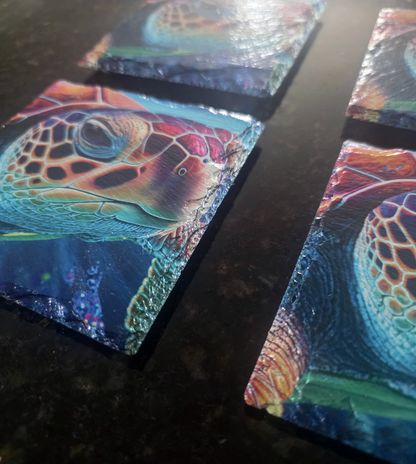 Angled detail of red sea turtle artwork printed on square slate coasters, showing the natural textured edges.