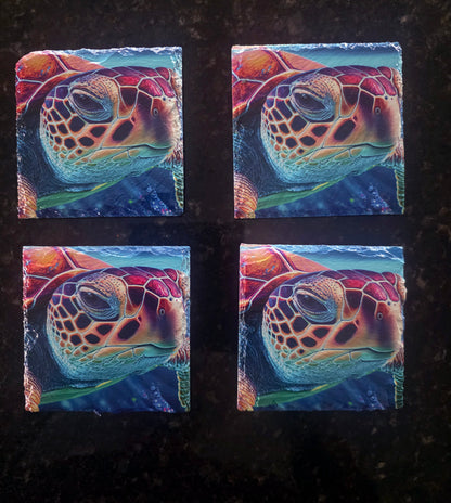 Four square slate coasters featuring a close-up red, orange and turquoise sea turtle on a dark surface.