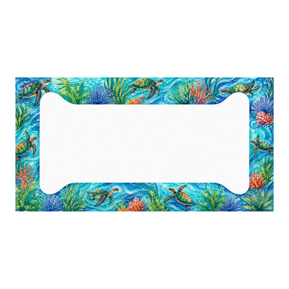 Aluminum license plate frame with green sea turtles, colorful coral and sea grass against turquoise water, shown in full on white.