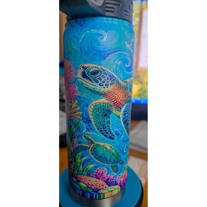 Close view of a large Hawaiian honu and smaller sea turtle on the blue ocean bottle design.