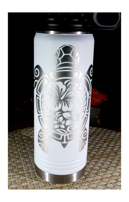 Front view of a white water bottle with silver engraved tribal sea turtle artwork filled with hibiscus and plumeria flowers.
